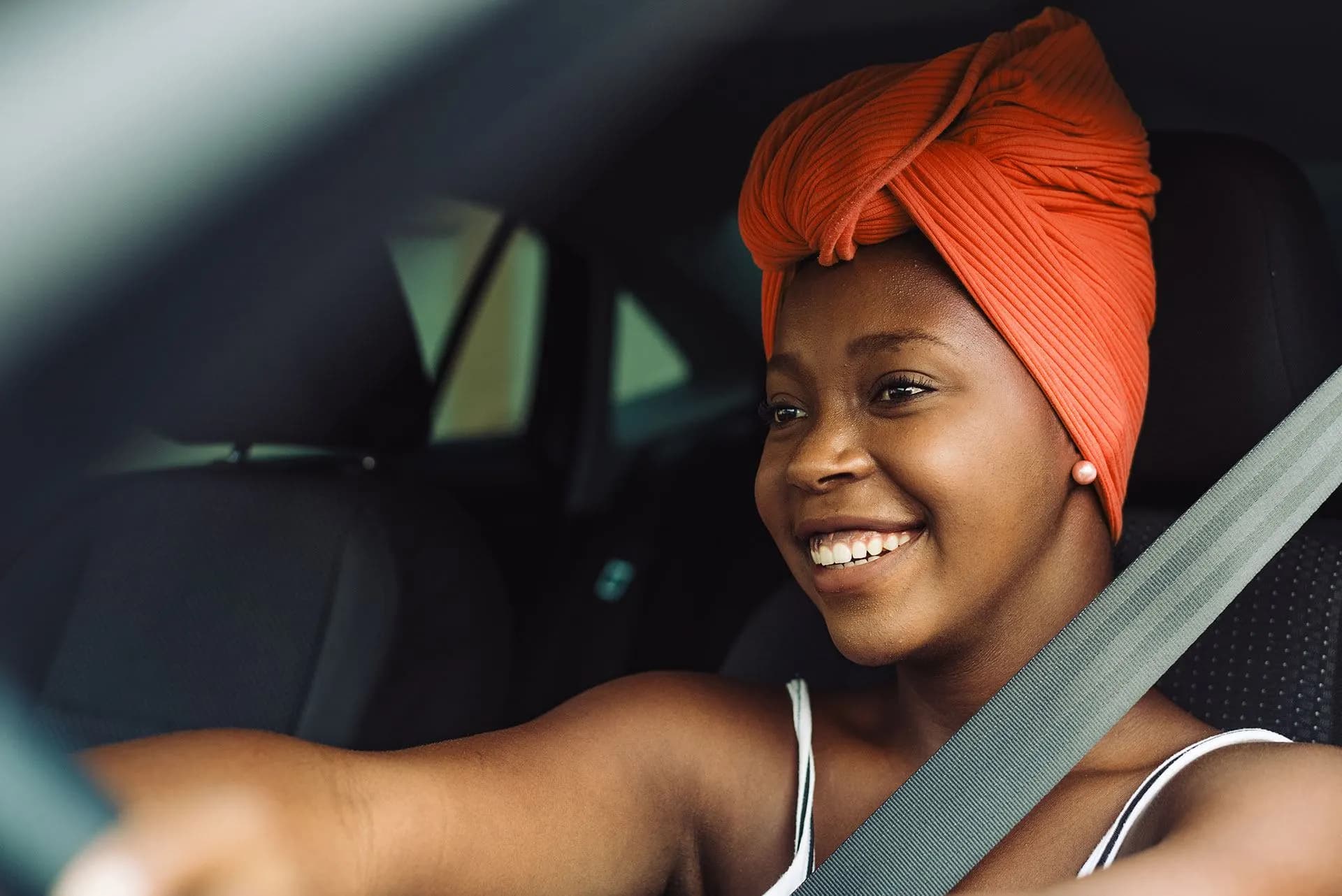 A driver smiling at the wheel